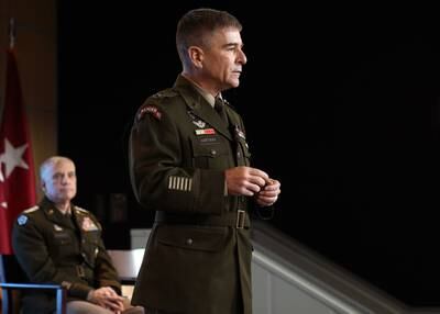 Army Maj. Gen. William J. Hartman, commander of Cyber National Mission Force, foreground, and Gen. Paul Nakasone, leader of U.S. Cyber Command, background, are seen at ceremony in December 2022.