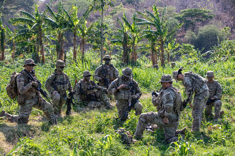 A group of U.S. Army soldiers discusses a mission plan during a rehearsal for a live-fire event during Exercise Super Garuda Shield 2023 in Indonesia.