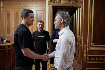 Ukrainian Minister of Digital Transformation shakes hands with Palantir Technologies CEO Alex Karp during a meeting in Kyiv in June 2022.