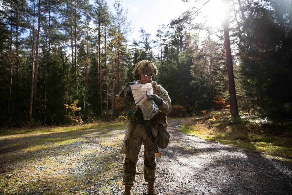 Pfc. Lobo Thomas, attached to the 2nd Cavalry Regiment, navigates using a map for land navigation testing in Germany on Nov. 6, 2023.
