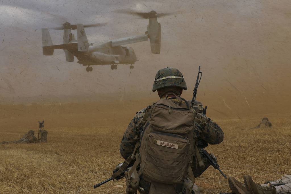 A U.S. Marine with Special Purpose Marine Air-Ground Task Force-Crisis Response-Africa 20.2, Marine Forces Europe and Africa, watches an MV-22B Osprey land at a landing zone during a tactical recovery of aircraft and personnel in Albacete, Spain, July 9, 2020.