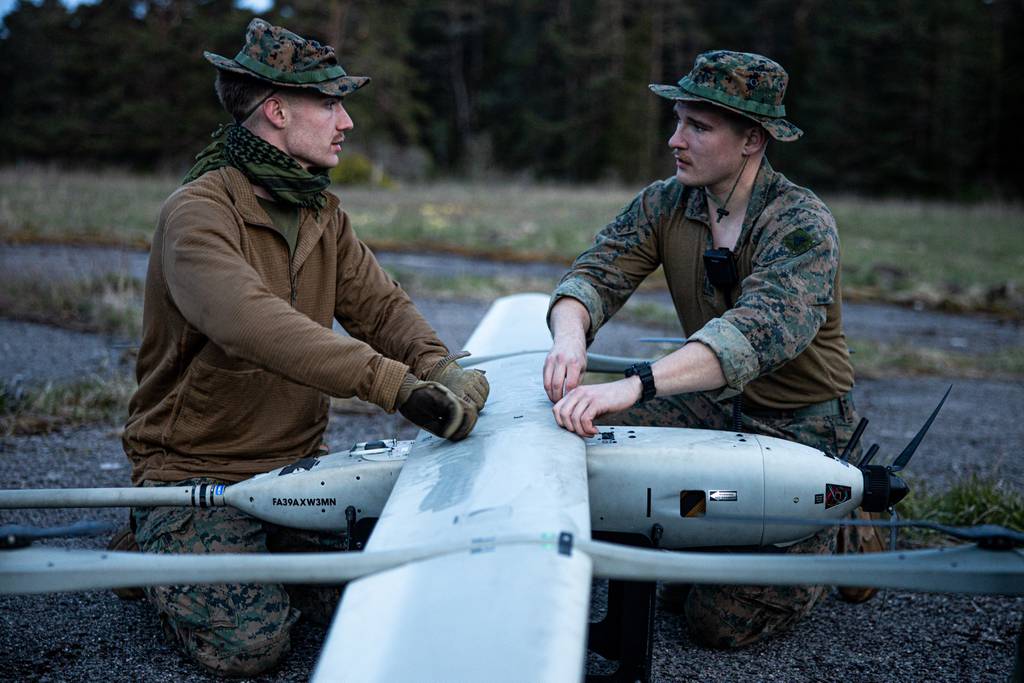 U.S. Marine Corps Cpl. Jordan Chaussepied, right, and Cpl. William Horton assemble a VXE-30 Stalker unmanned aircraft system during Exercise Hedgehog 22 near Saaremaa, Estonia, in May 2022.