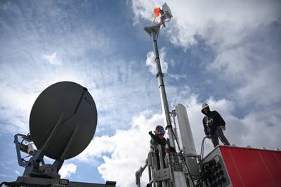 A work crew prepares a 5G mobile test station for trials at Hill Air Force Base, Utah, in February 2022.
