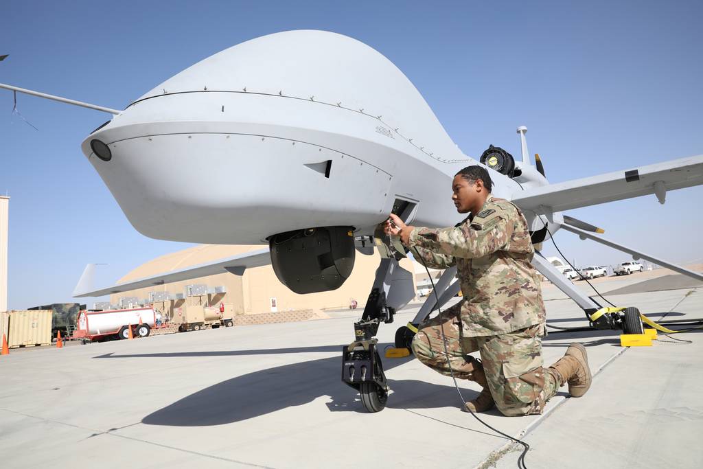 U.S. Army PFC Terry Hollywood conducts maintenance on a Gray Eagle in preparation for Project Convergence at Yuma Proving Ground, Arizona.