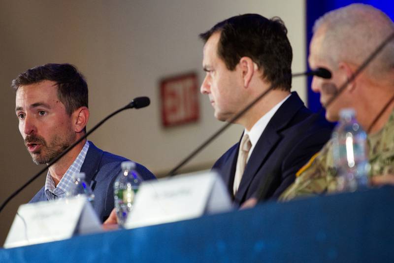 Mark Kitz, the U.S. Army's program executive officer for intelligence, electronic warfare and sensors, speaks May 24, 2023, at a conference in Philadelphia. Two other PEOs are seen to the right.