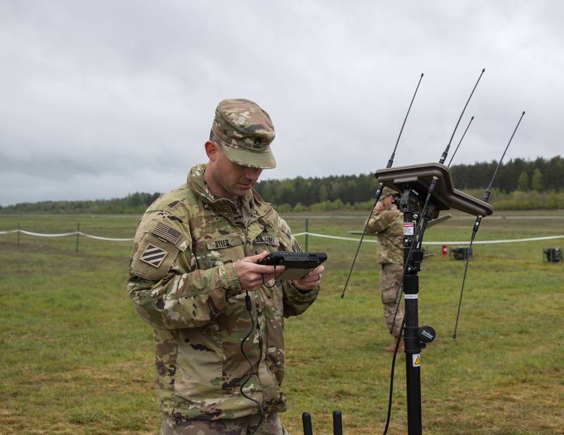 Staff Sgt. Paul Dykes, a 17E electronic warfare specialist, demonstrates how to utilize electronic warfare equipment to Polish military officials in 2020.