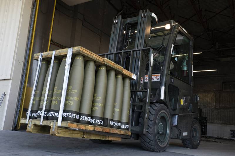 Airmen with the 436th Aerial Port Squadron use a forklift to move 155 mm shells ultimately bound for Ukraine, April 29, 2022, at Dover Air Force Base, Del.