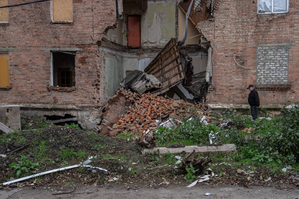 A man looks at a building hit by a Russian missile strike on Oct. 21, 2022, in Bakhmut, Donetsk oblast, Ukraine.