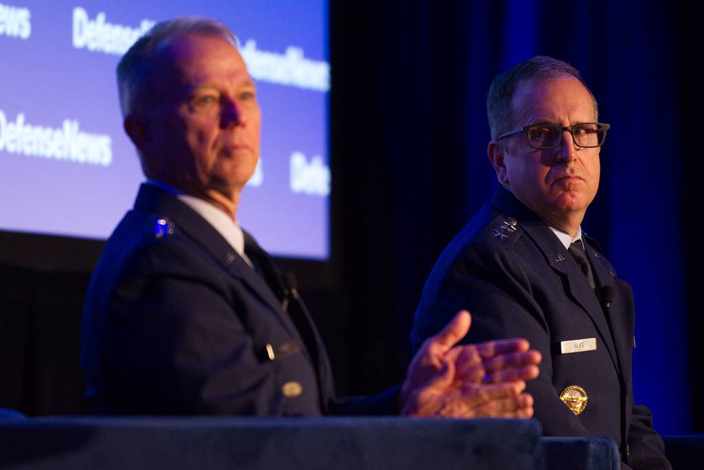 U.S. Air Force Lt. Gen. James Slife listens to Gen. Mark Kelly during a panel discussion at the Sept. 6, 2023, Defense News Conference in Pentagon City.