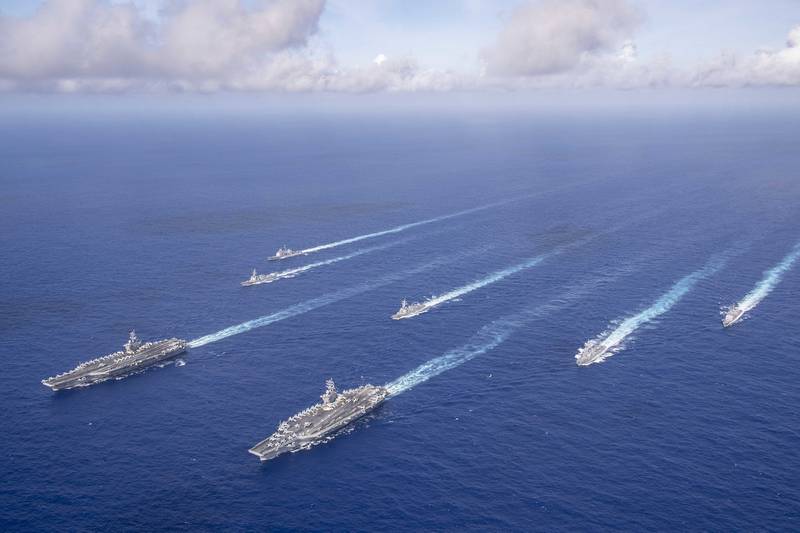 The Theodore Roosevelt and Nimitz carrier strike groups transit the Philippine Sea in formation while conducting dual carrier and airwing operations on June 23, 2020.