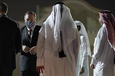 Secretary of State Mike Pompeo prepares to board a plane at Old Doha International Airport, Saturday, Nov. 21, 2020, in Doha, Qatar. Pompeo is en route to the United Arab Emirates.
