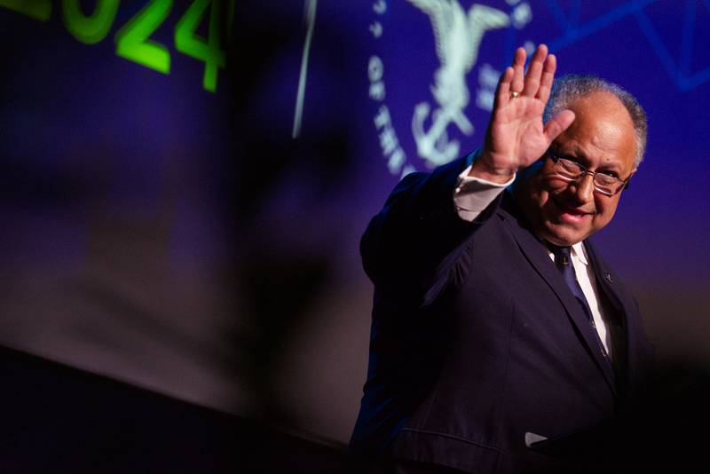 U.S. Navy Secretary Carlos Del Toro waves at the crowd gathered for his speech at the 2024 Sea-Air-Space defense conference in Maryland.