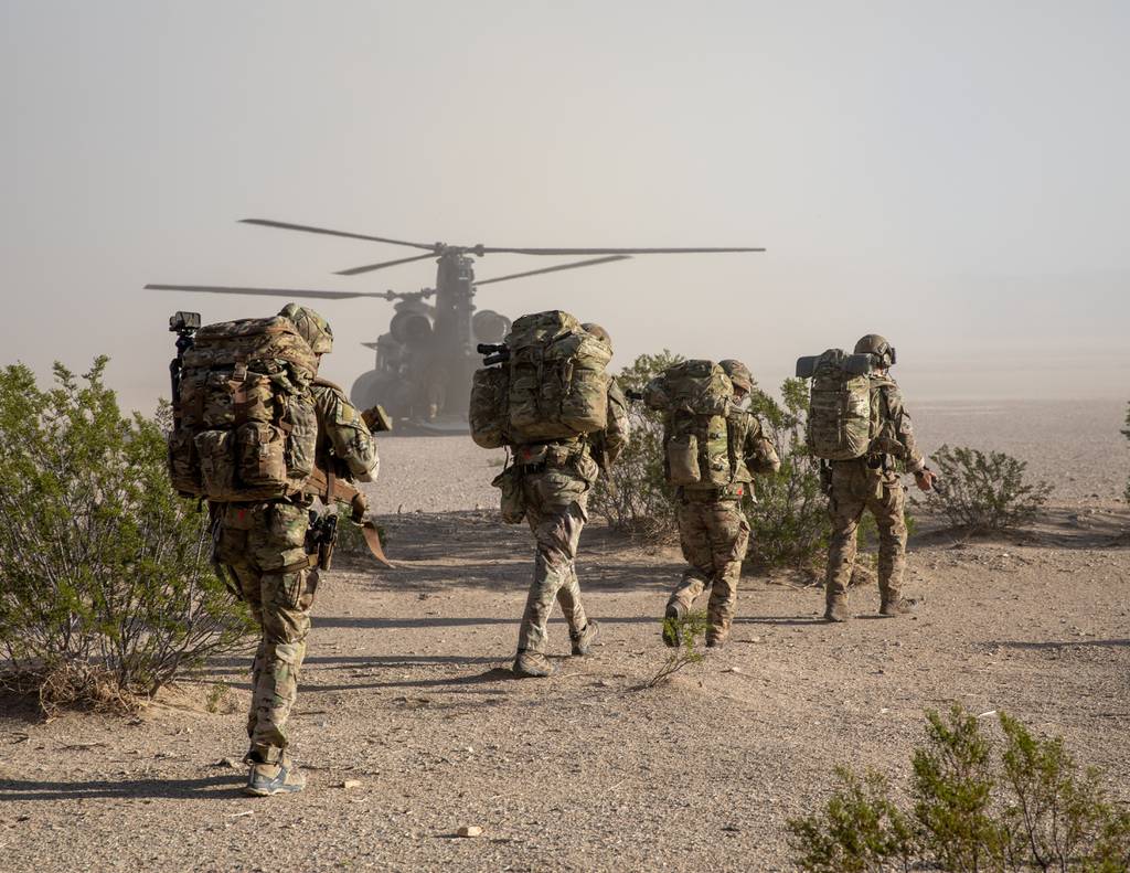 U.S. soldiers assigned to 7th Special Forces group and British Rangers assigned to 4th Rangers board a CH-47 Chinook during Project Convergence 22 at Fort Irwin, California.