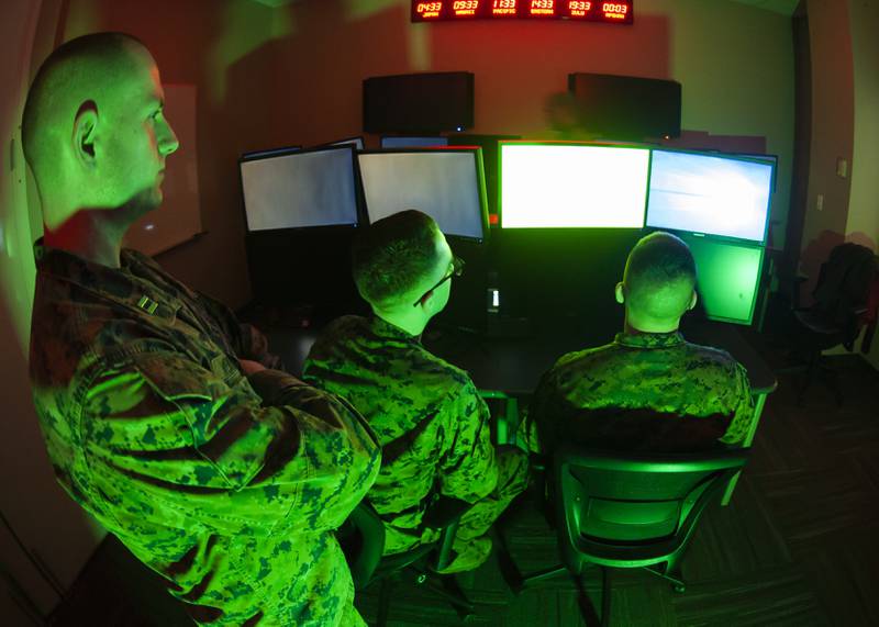 Marines with U.S. Marine Corps Forces Cyberspace Command pose for photos in a cyber operations room at Fort Meade, Maryland, in February 2020.