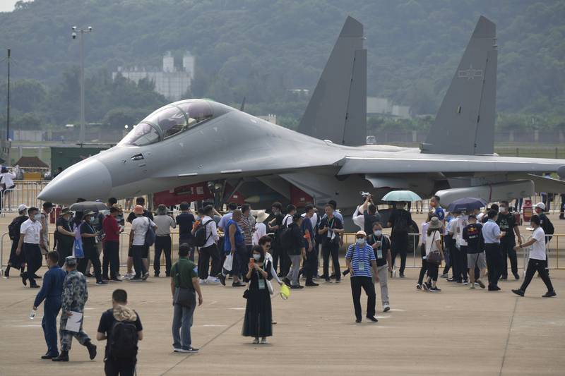 Visitors look at the J-16D electronic warfare variant of the Chinese military's J-16 airplane during 13th China International Aviation and Aerospace Exhibition, also known as Airshow China 2021 in Zhuhai, southern China, on Wednesday, Sept. 29, 2021.