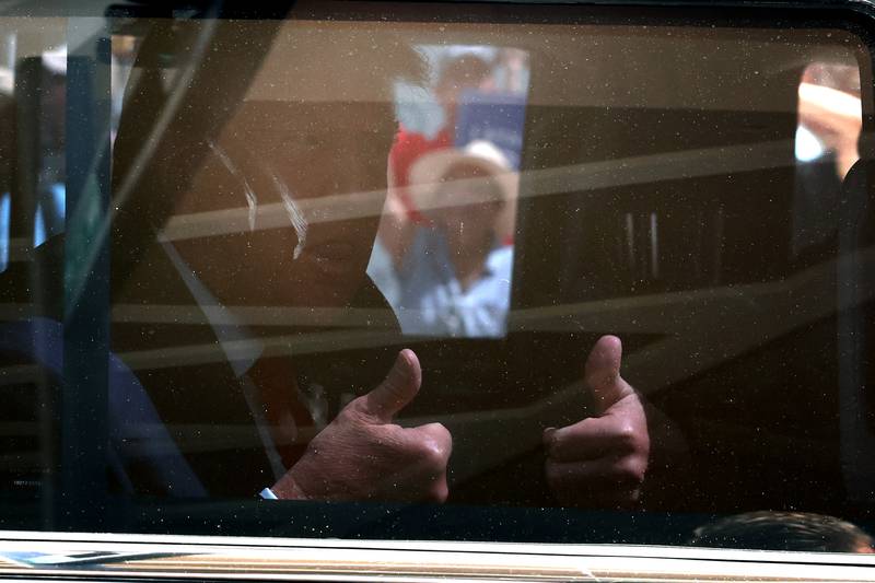 Former President Donald Trump gives a thumbs up as he departs the Wilkie D. Ferguson Jr. federal courthouse following his arraignment June 13, 2023, in Miami, Florida.