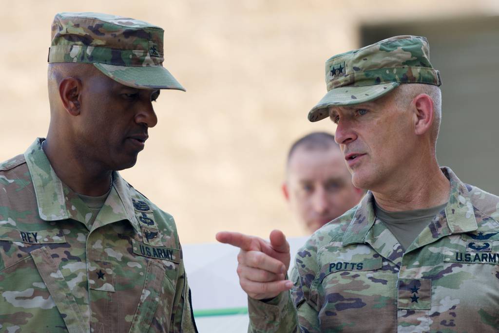 U.S. Army Brig. Gen. Jeth Rey and Maj. Gen. Anthony Potts converse on the sidelines of an event in Delaware on Aug. 9, 2022.