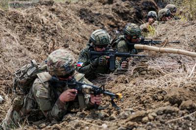 U.S. soldiers and Philippine soldiers advance on a breaching site at Fort Magsaysay during the Balikatan 23 exercise.