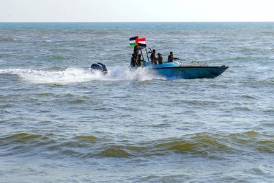 Members of the Yemeni Coast Guard, affiliated with the Houthi group, patrol the sea as demonstrators march through the Red Sea port city of Hodeida on Jan. 4, 2024.