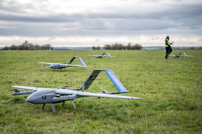 A handful of Blue Bear drones are seen in a field during artificial intelligence and autonomy testing among AUKUS partners in April 2023.