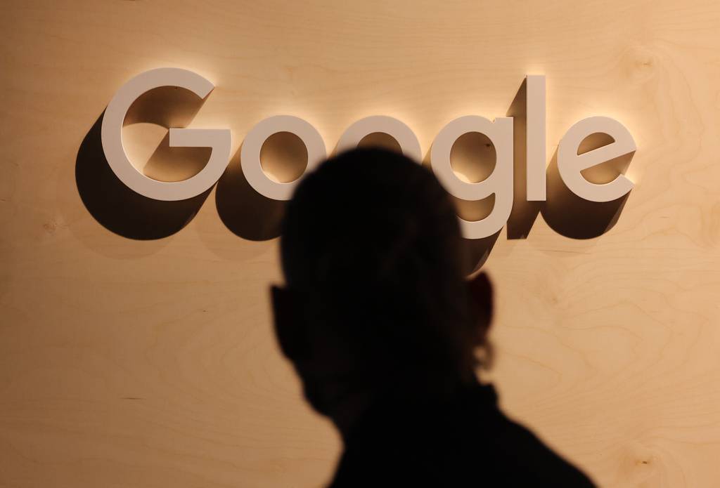 A person walks past a Google logo at a stand at the 2022 Re:publica digital society festival in Berlin, Germany.