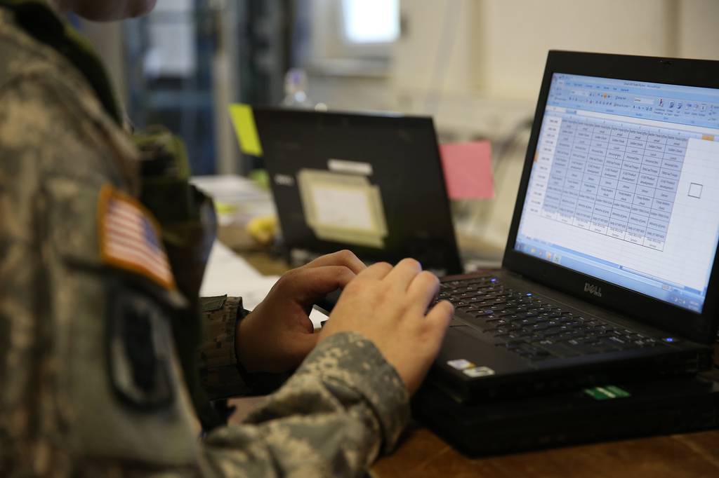 A U.S. soldier types on a keyboard while conducting tactical operations center operations during Rotation 14-09 at the Joint Multinational Readiness Center in Hohenfels, Germany, Oct. 7, 2014.