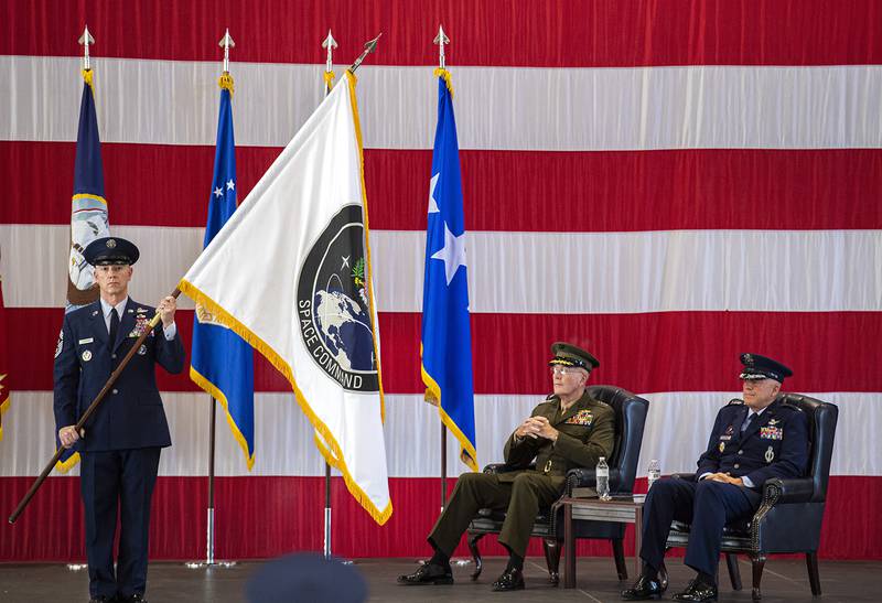 Air Force Gen. John W. Raymond, commander of the U.S. Space Command, right, and Marine Corps Gen. Joseph F. Dunford Jr., chairman of the Joint Chiefs of Staff, watch during the presentation of the new U.S. Space Command colors Monday, Sept. 9, 2019, during a ceremony to recognize the establishment of the United States Space Command at Peterson Air Force Base in Colorado Springs, Colo.