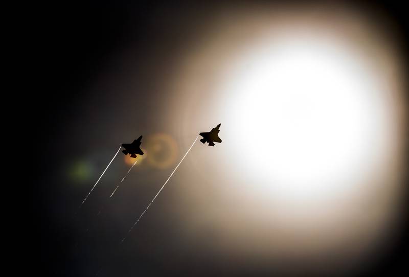 A pair of F-35 Lightning IIs pass under the sun near Eglin Air Force Base, Florida.