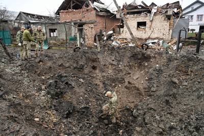 Police experts examine a crater after a missile strike in a village near the western Ukrainian city of Lviv on Nov. 16, 2022.