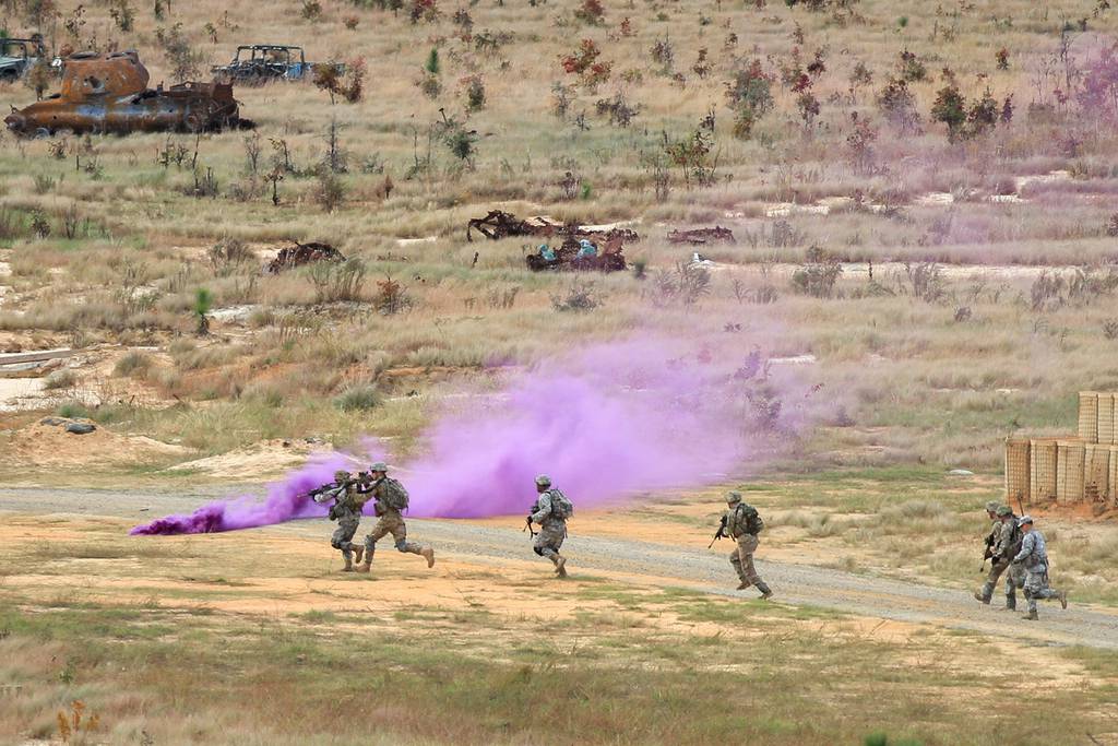 Paratroopers assigned to the 82nd Airborne Division move through smoke toward an objective during rehearsals for a live-fire exercise on Fort Bragg, North Carolina, in 2015.