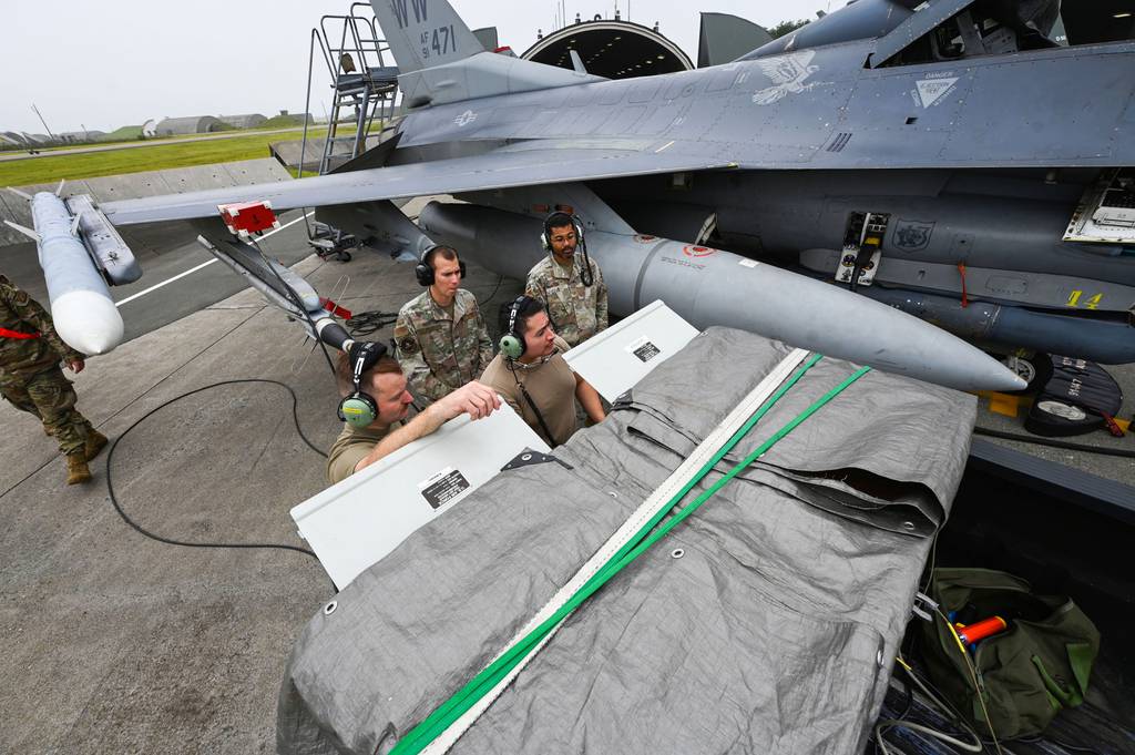 U.S. airmen assess the defensive system readiness of an F-16 Fighting Falcon at Misawa Air Base, Japan, on Aug. 8, 2023.