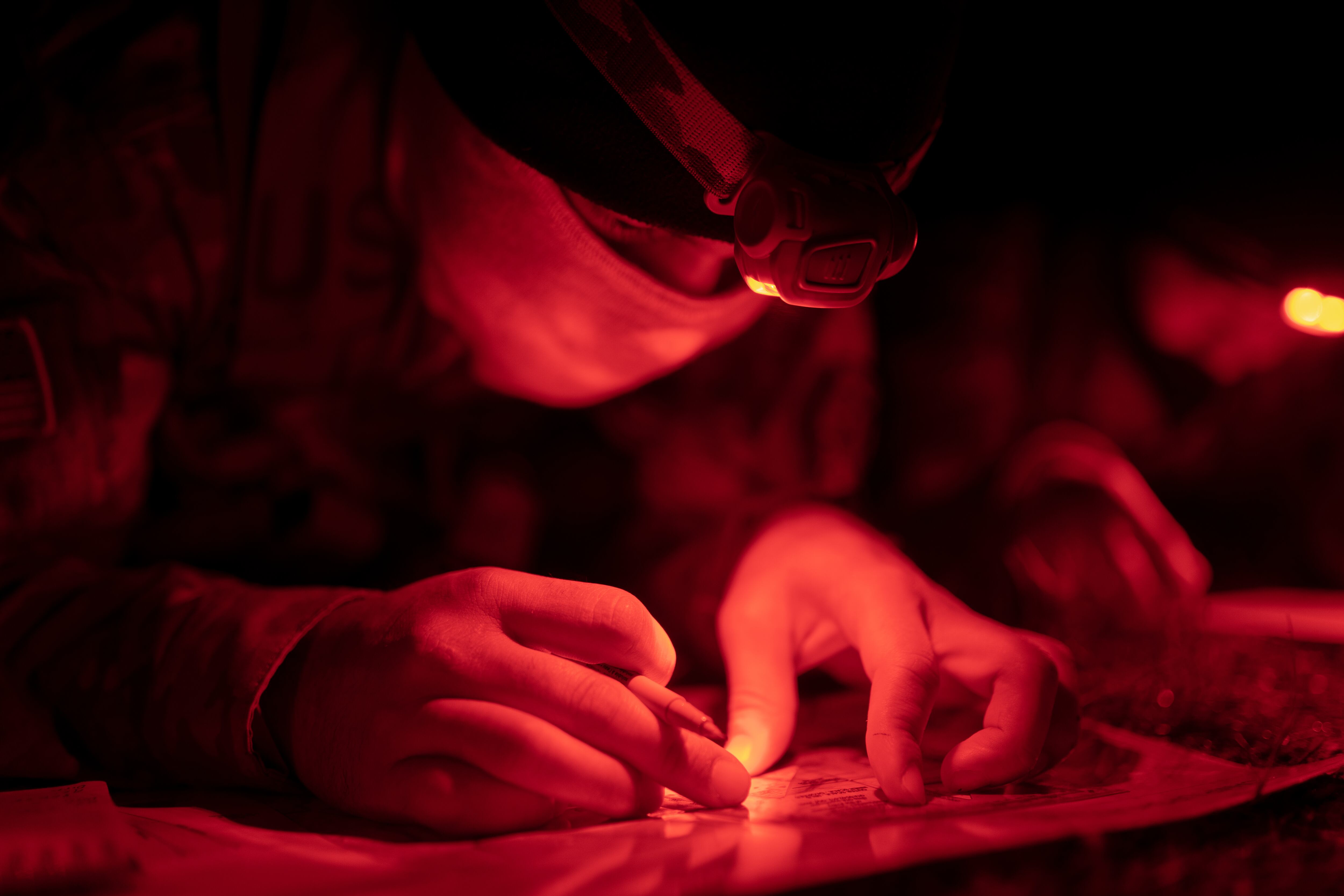 Victor Rivas, a cadet with the Bowie State University ROTC program, plots his points on a map during a night land navigation in Virginia on Nov. 7, 2020.