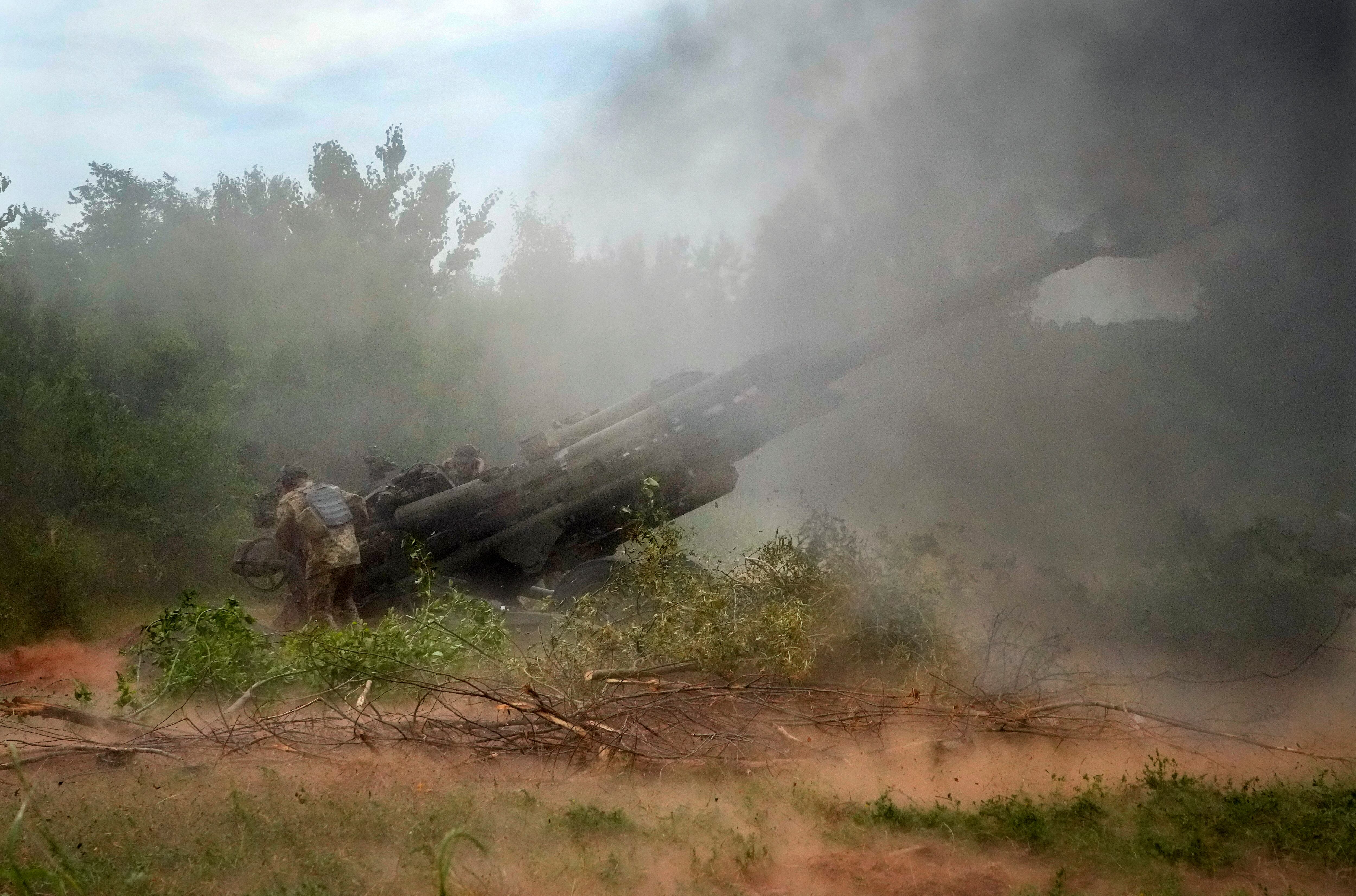 Ukrainian soldiers fire at Russian positions from a U.S.-supplied M777 howitzer in Ukraine's eastern Donetsk region June 18, 2022.