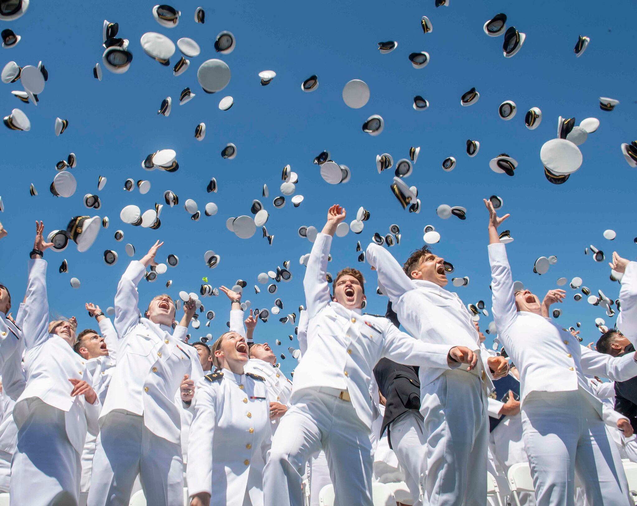 Midshipmen toss their covers in the air during the United States Naval Academy's Class of 2019 Graduation Day and Commissioning Ceremony